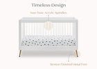 White crib with polka dot mattress cover on a white background, featuring text about design and materials. 16-Sloane 4-in-1 Acrylic Convertible Crib