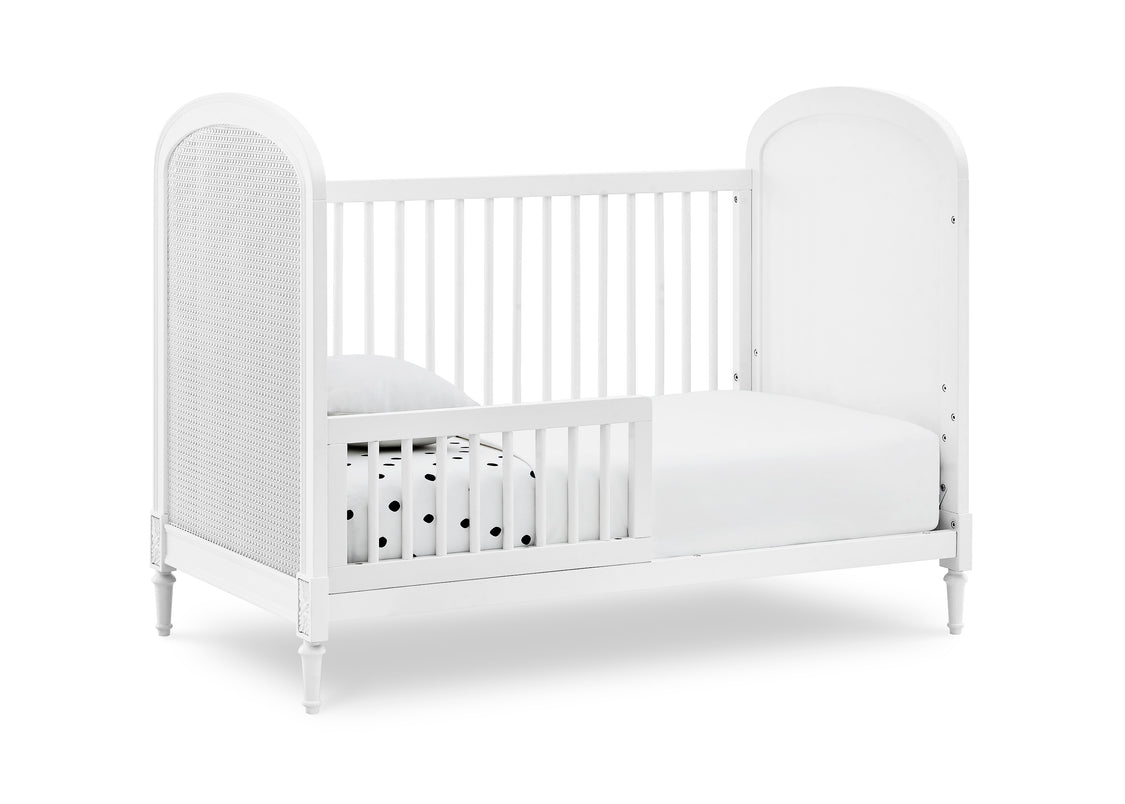 White crib with a white mattress on a white background