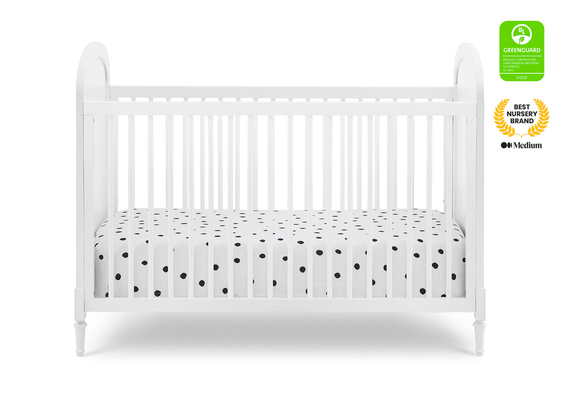 White crib with a polka dot mattress on a white background