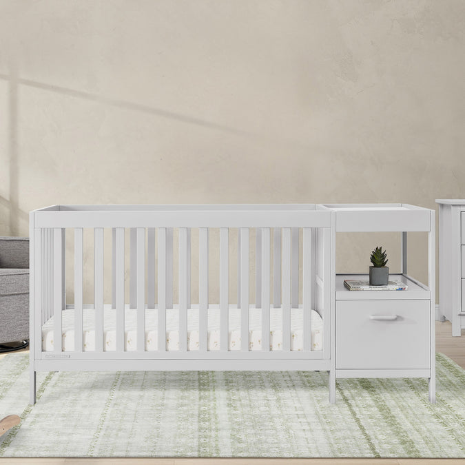 White crib with changing table in a nursery setting 35-Alice 5-in-1 Convertible Crib and Changer