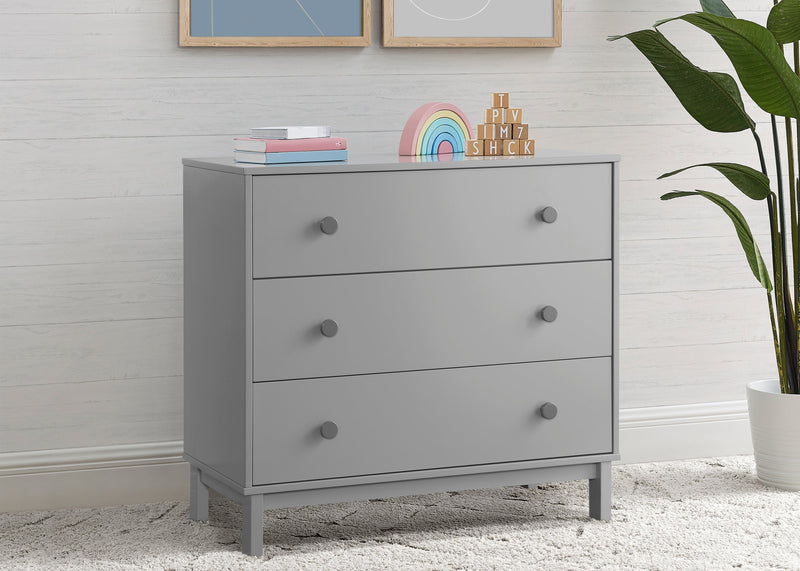 Gray dresser with decorative items in a room with a plant and framed pictures on the wall. 8-babyGap Legacy 3 Drawer Dresser with Interlocking Drawers