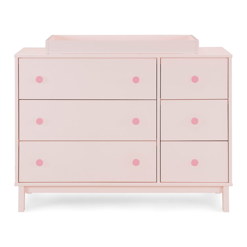 Pink dresser with polka dot accents on a white background