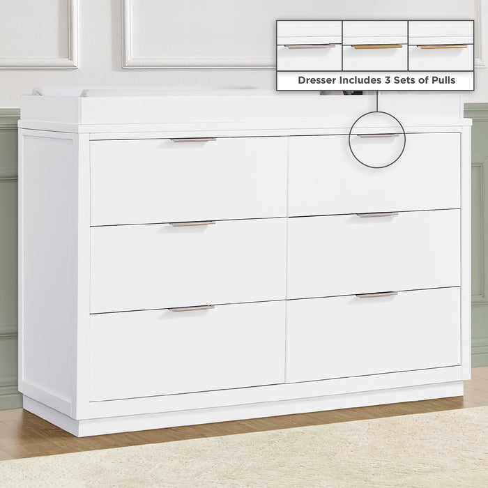 A white Forever 6 Drawer Dresser with interlocking drawers, placed against a green wall in a room with a changing top compatible with the dresser. 3-Forever 6 Drawer Dresser with Interlocking Drawers - Classic Collection