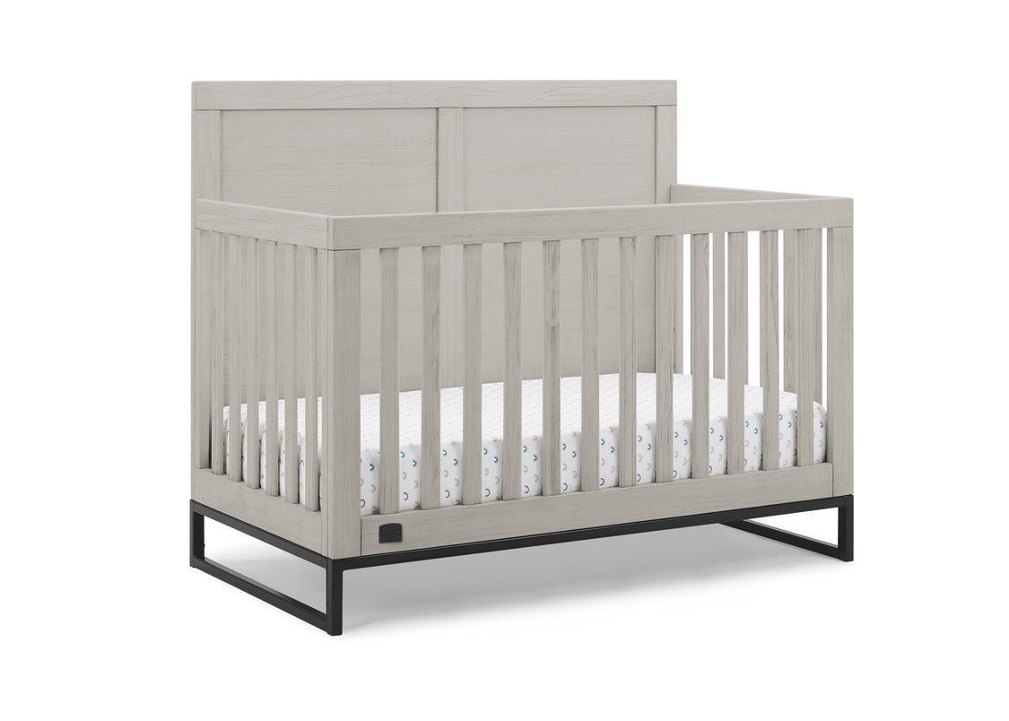 Gray crib with white mattress on a white background