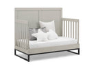 Gray crib with white bedding and pillows on a white background 31-Foundry 6-in-1 Convertible Crib