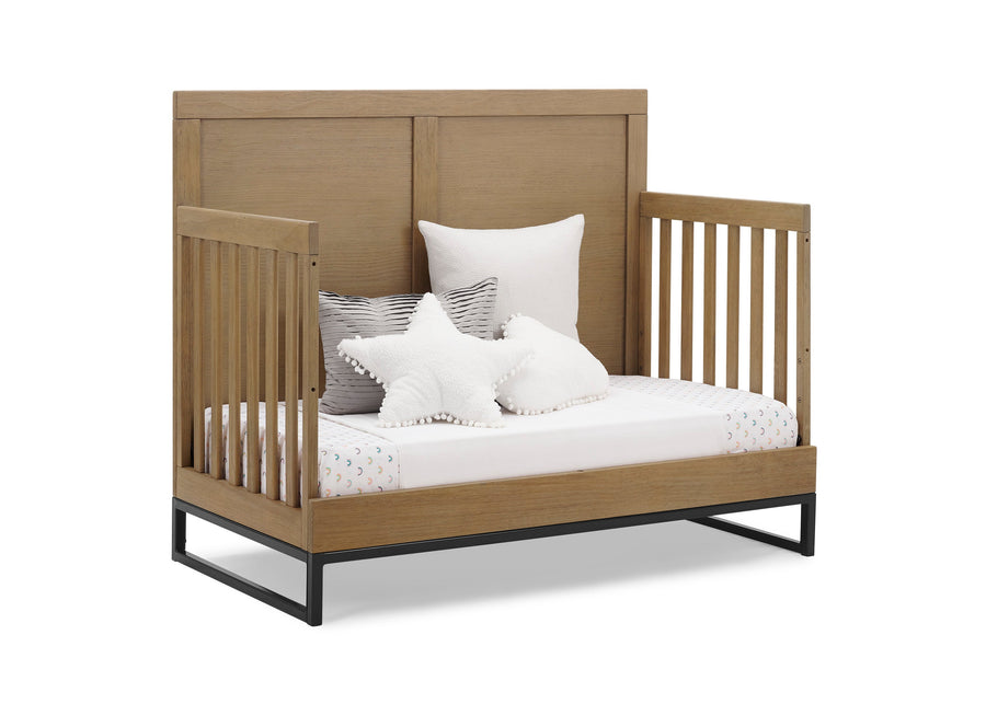 Wooden crib with white bedding and pillows on a white background 22-Foundry 6-in-1 Convertible Crib