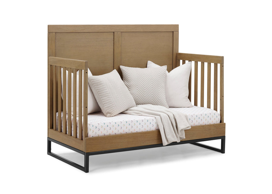 Wooden crib with white bedding and pillows on a white background 23-Foundry 6-in-1 Convertible Crib