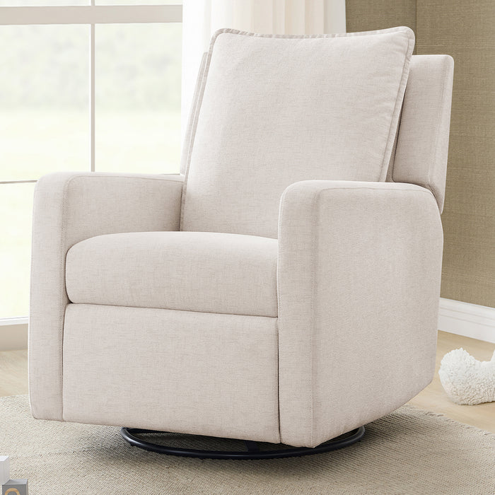A blue babyGap Harlowe Power Recliner with USB-A and Type-C ports, located in a room near a window, with a white toy on the floor and a wooden crib in the background. 2-Harlowe Power Recliner and Swivel Glider with USB-A and Type-C Ports in Stain-Resistant Performance Fabric