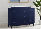 Navy blue dresser with white top in a room with a plant and framed pictures. 23-babyGap Legacy 6 Drawer Dresser with Interlocking Drawers