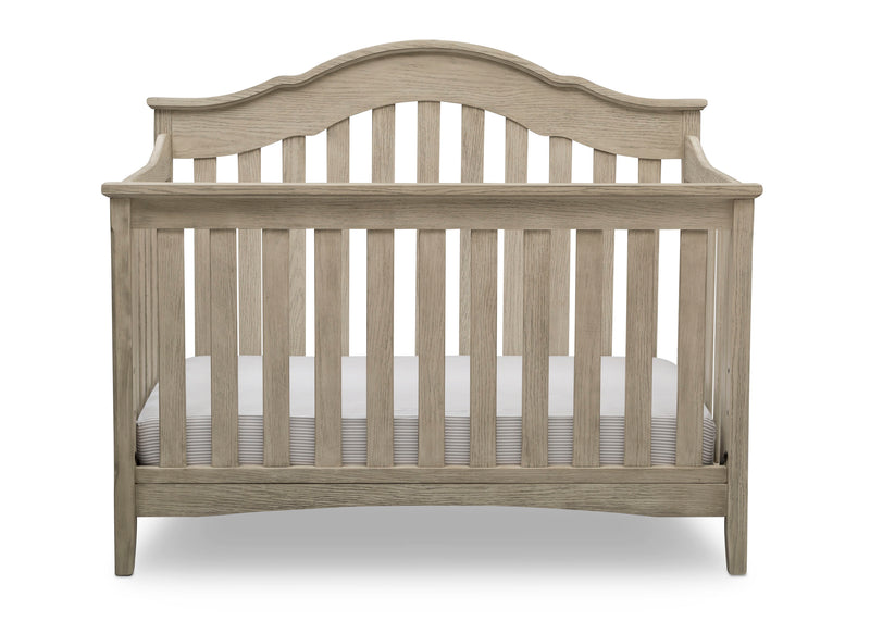Wooden crib with a white mattress on a white background
