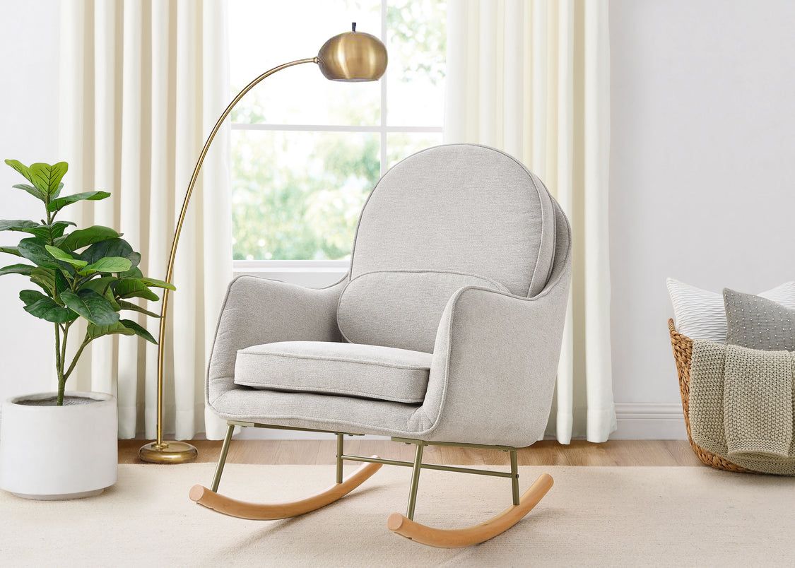 Gray rocking chair in a bright room with a plant and basket.