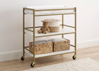 Gold-framed rolling cart with white top and shelves, containing a teddy bear and woven baskets on a wooden floor. 4-Jade Changing Table
