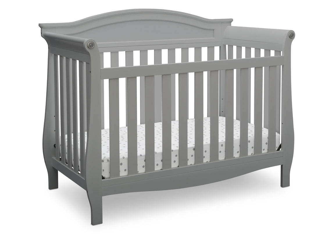 Gray crib with white mattress on a white background