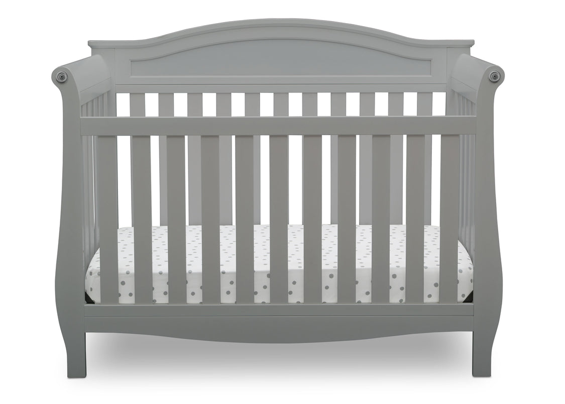 Gray crib with a white mattress on a white background