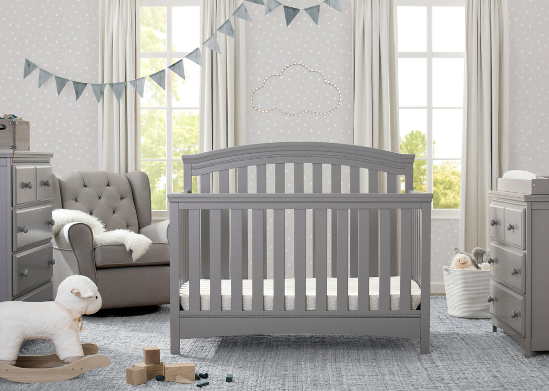 Nursery room with a gray crib, toys, and furniture.
