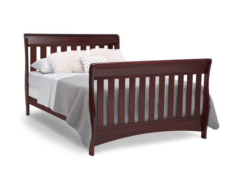 Wooden sleigh bed with bedding on a white background