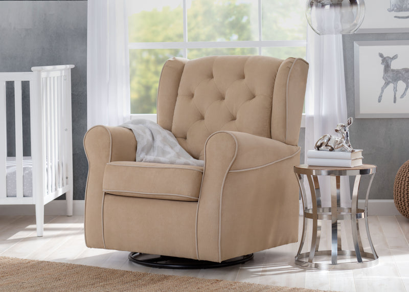 A beige upholstered recliner chair with tufted backrest and rolled arms, shown in a styled nursery setting next to a glass side table and crib. 20-Emerson Nursery Glider Swivel Rocker Chair