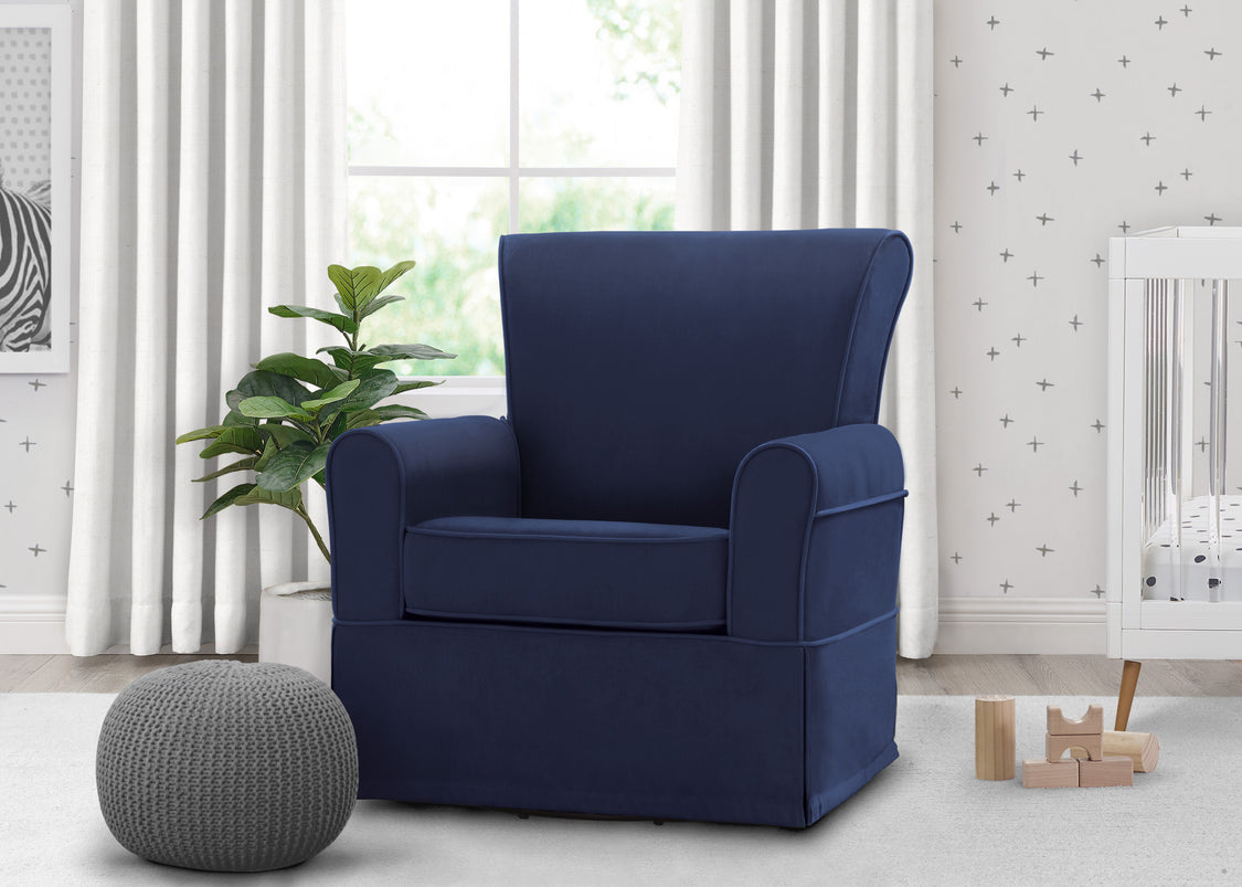 Navy blue armchair in a room with white curtains and a plant.
