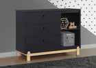 Black dresser with wooden legs in a room with gray walls and a polka dot pattern. 8-Poppy 3 Drawer Dresser with Cubbies