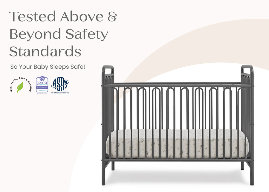 Gray crib with safety standards text and logos on a white background 16-Darcy 4-in-1 Convertible Metal Crib