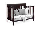 Wooden crib with pillows and a blanket on a white background 11-Richmond 6-in-1 Convertible Baby Crib