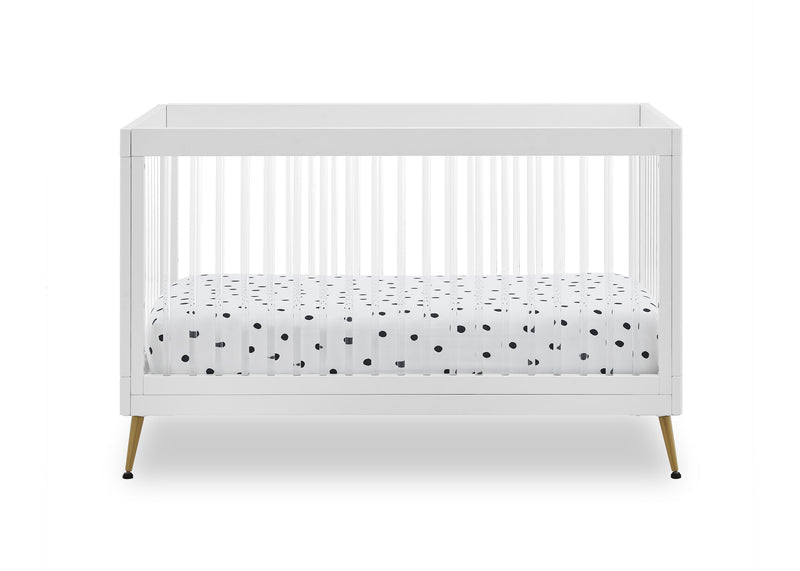 White crib with a polka dot mattress on a white background