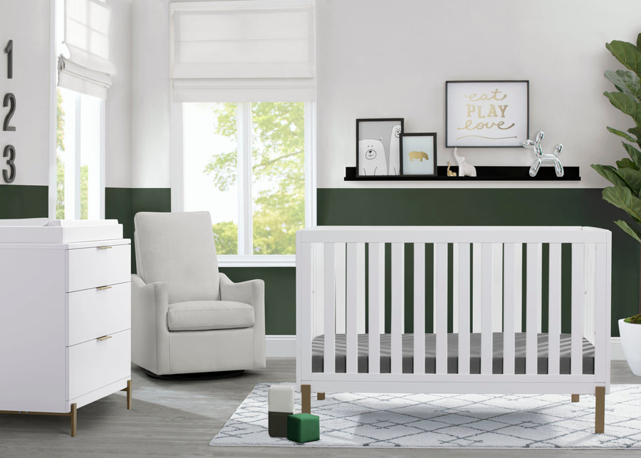 Nursery room with white crib, armchair, and changing table in a bright room. 17-Hendrix 4-in-1 Convertible Crib