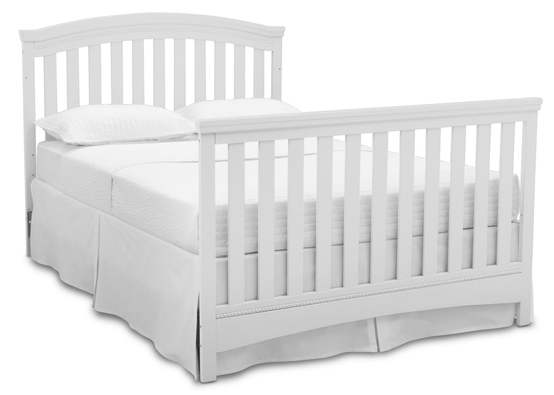 White crib with mattress on a white background
