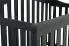 Close-up of a black wooden crib with slatted design. 19-Farmhouse 6-in-1 Convertible Baby Crib