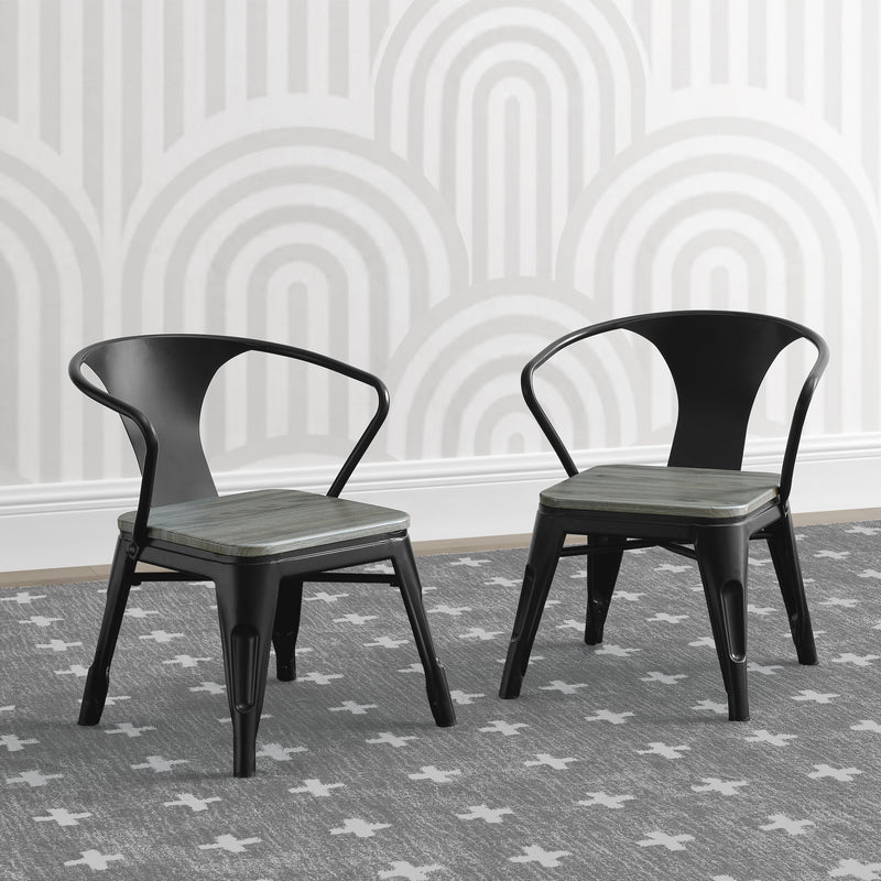 Two black metal chairs with wooden seats against a white wall with geometric patterns.