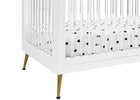 White crib with gold legs and a black and white polka dot fitted sheet. 22-Sloane 4-in-1 Acrylic Convertible Crib