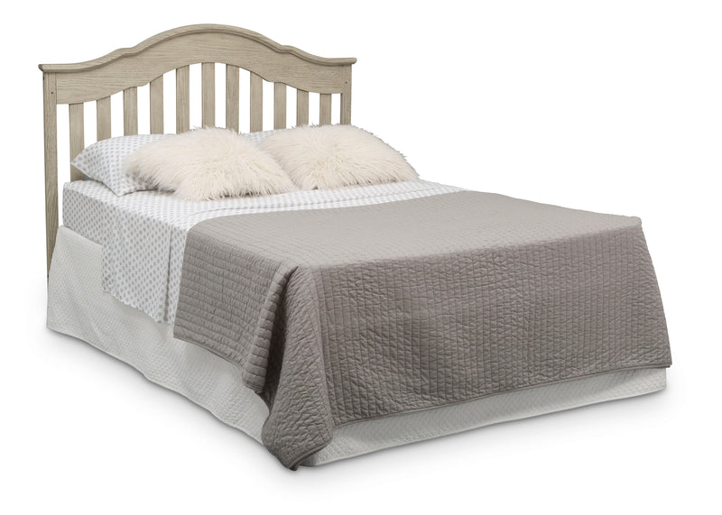 Bed with gray bedding and white pillows on a white background