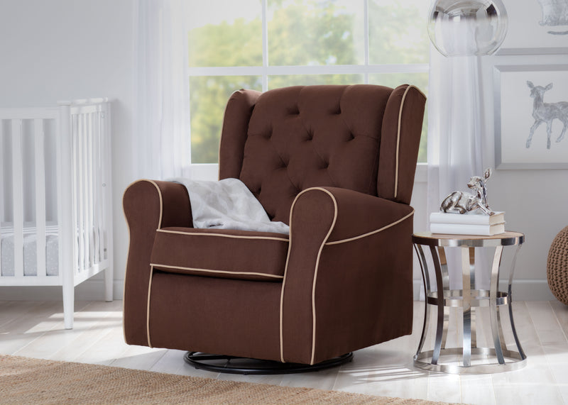 A brown tufted fabric swivel glider chair with cream piping, styled in a bright nursery next to a white crib and a small side table. 16-Emerson Nursery Glider Swivel Rocker Chair
