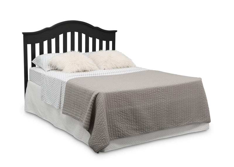 Bed with black headboard, gray bedding, and white pillows on a white background