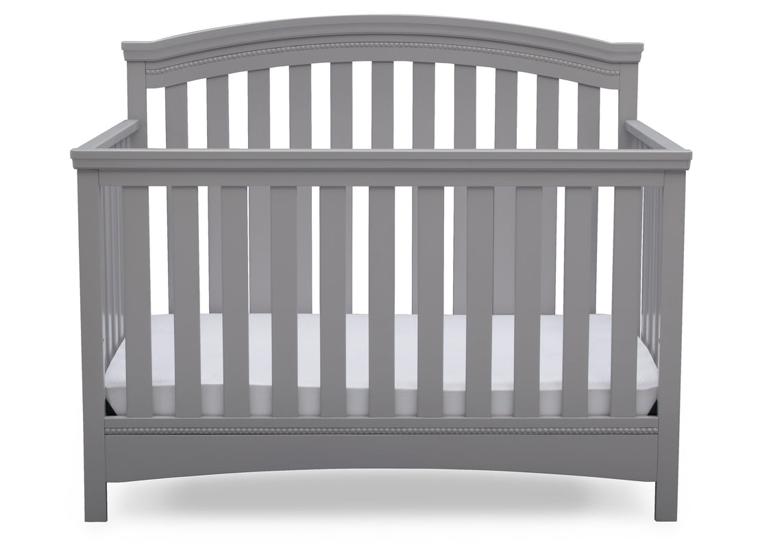 Gray crib with white mattress on a white background