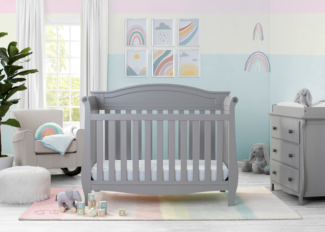 Nursery room with a gray crib, changing table, and decorative elements.
