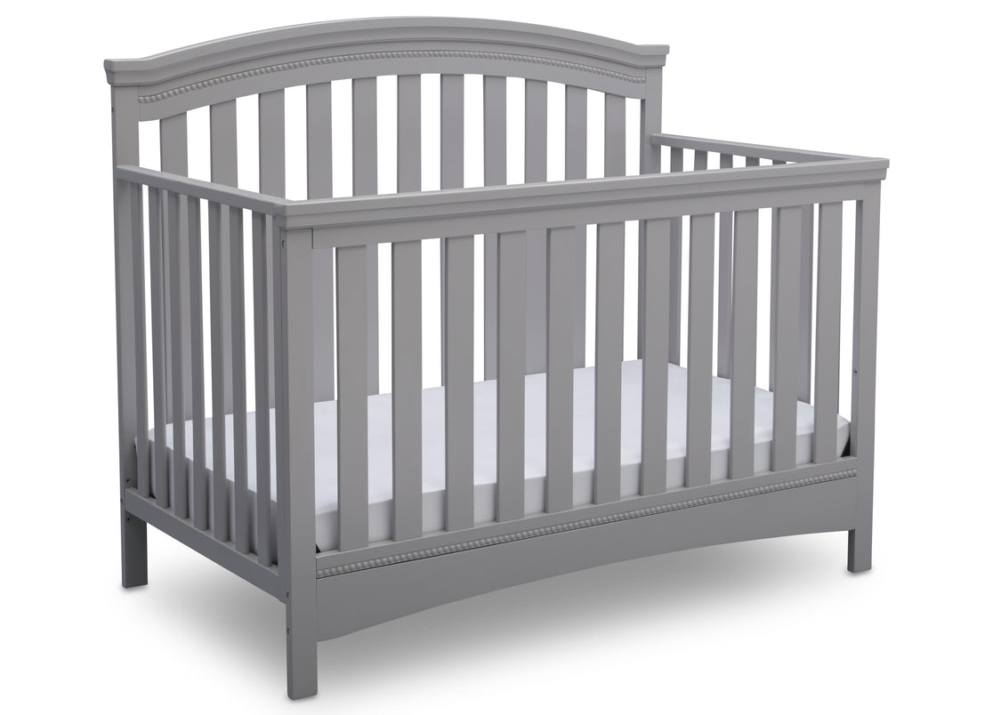 Gray crib with white mattress on a white background