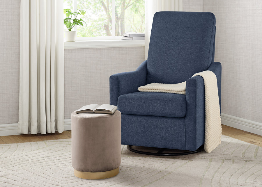 Blue recliner chair with a beige ottoman and blanket in a room with a window and curtains. 9-Andie Nursery Glider Swivel Chair with LiveSmart Fabric