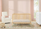Nursery room with wooden crib, white chair, and dresser against a striped wall. 31-Lulu 5-in-1 Convertible Crib