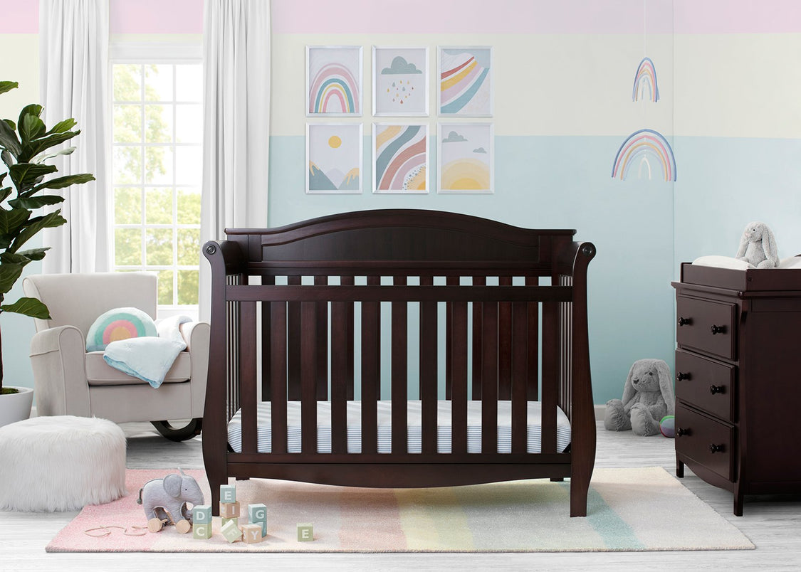 Nursery room with a wooden crib, dresser, and colorful decor.