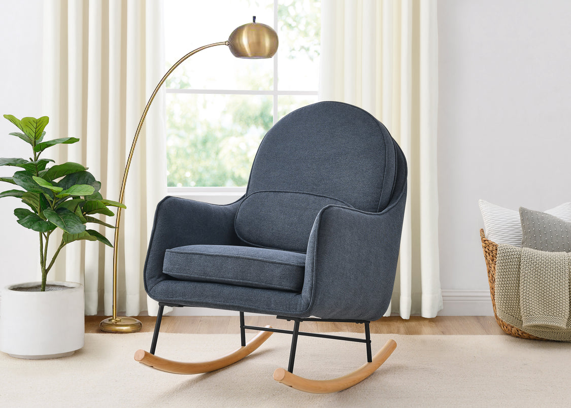 Blue rocking chair in a room with a plant, lamp, and basket.