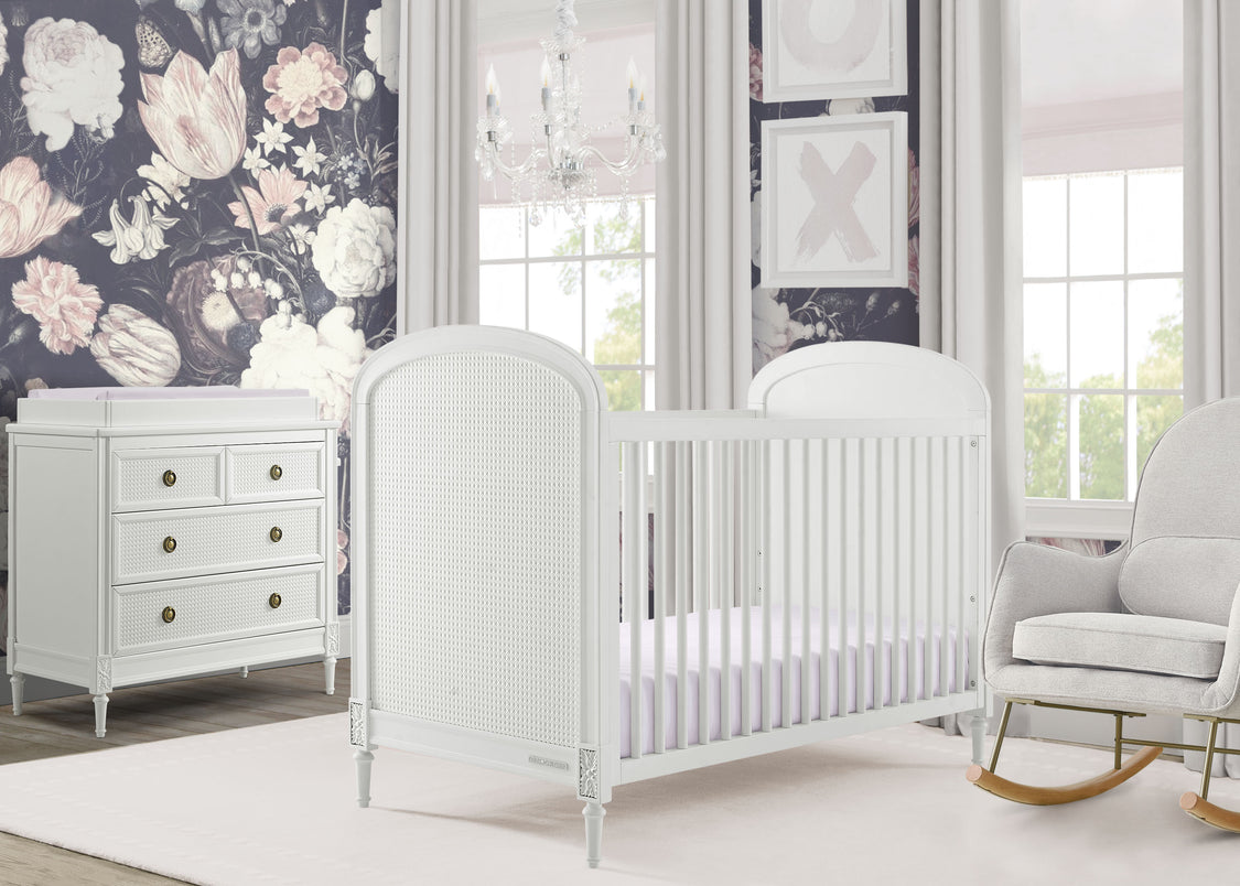 Nursery room with white crib, dresser, and rocking chair against a floral wall.