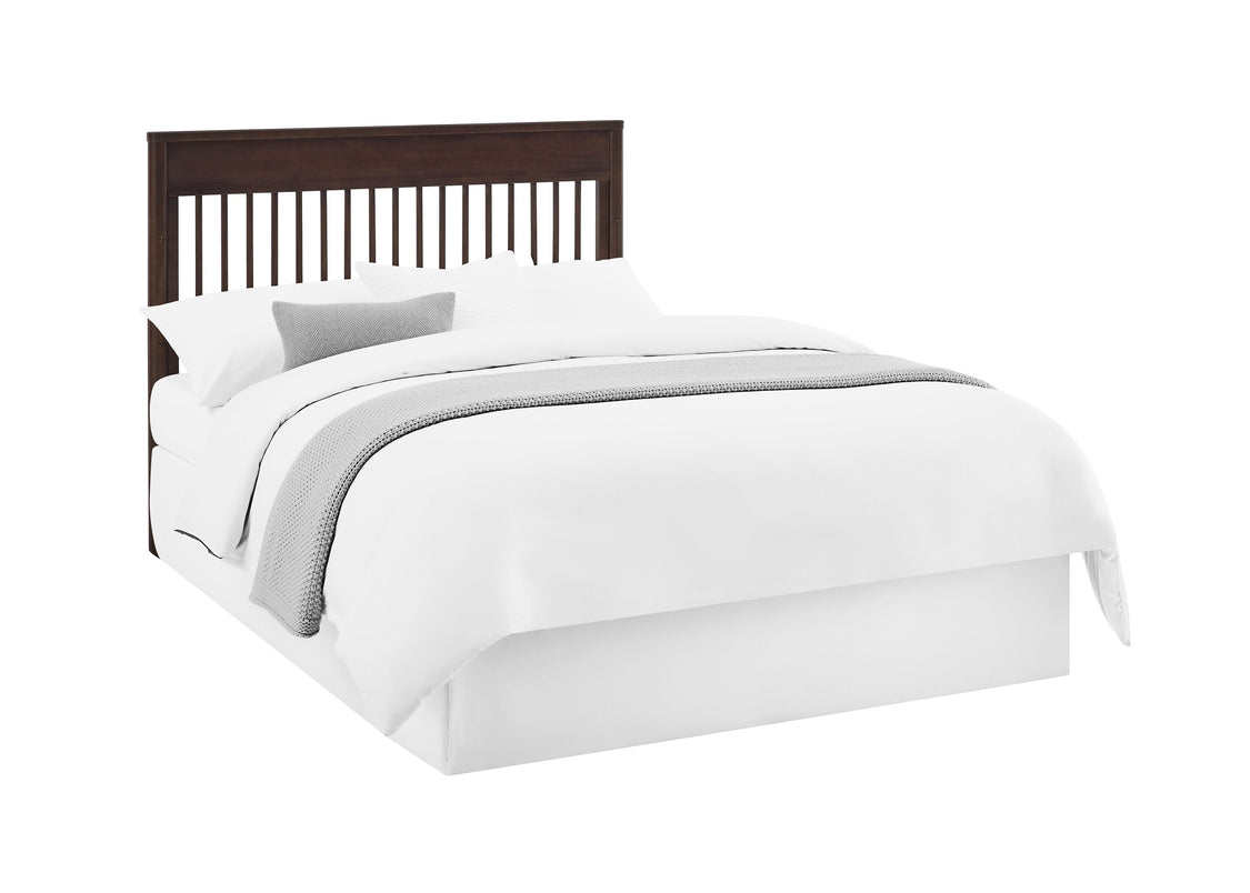 Bed with white bedding and a dark wood headboard on a white background