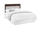 Bed with white bedding and a dark wood headboard on a white background 10-Remy 6-in-1 Convertible Crib