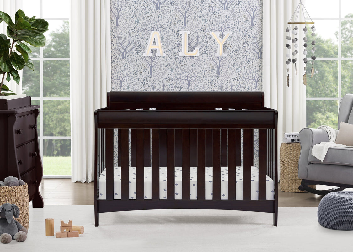 Nursery room with a dark wood crib, dresser, and decorative elements.