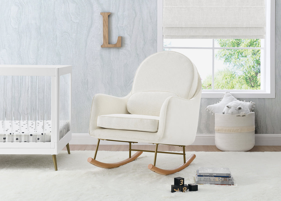 White rocking chair in a nursery with a crib and window in the background