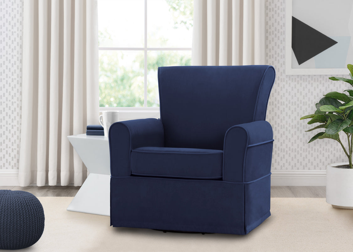 Navy blue armchair in a living room setting with light-colored walls and decor.