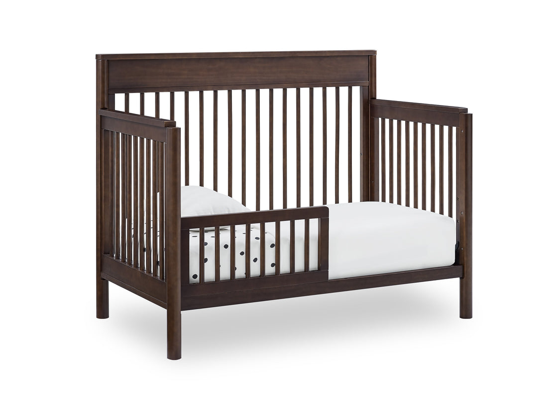 Wooden crib with white mattress on a white background