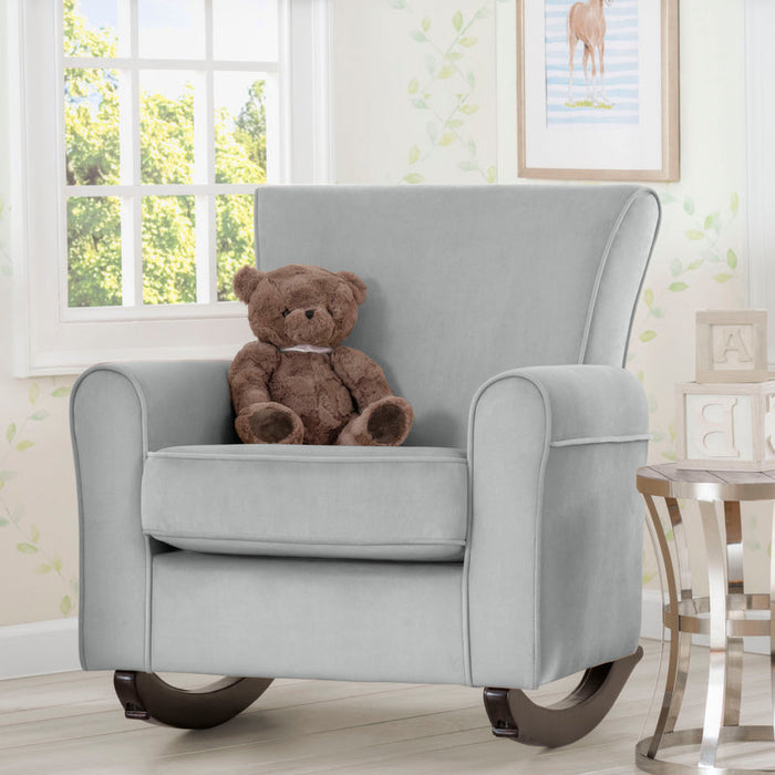 Gray rocking chair with a teddy bear in a room with a window and framed picture on the wall. 1-Lancaster Rocking Chair featuring LiveSmart Fabric by Culp