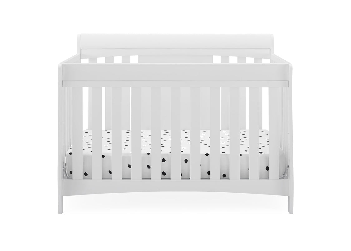White crib with black dot pattern on a white background